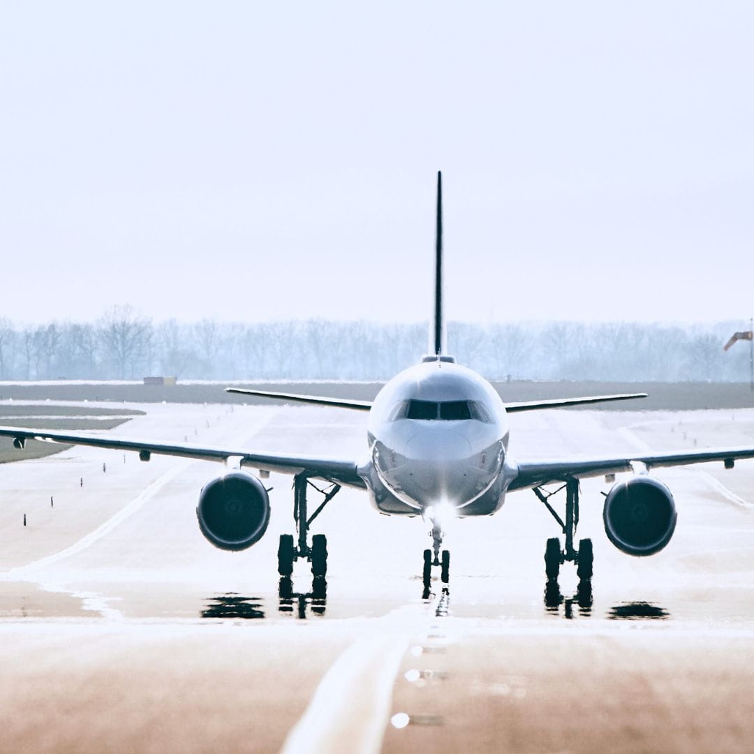 Commercial airliner taxiing on the tarmac for an airline sub-charter replacement flight.
